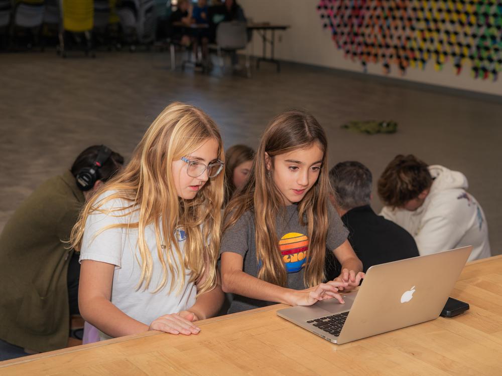 Fifth graders Kenley Taylor (left) and Gabby De Sa (right) work on story outlining during a MagTV morning meeting at Magnolia Elementary School in Carlsbad, Calif.