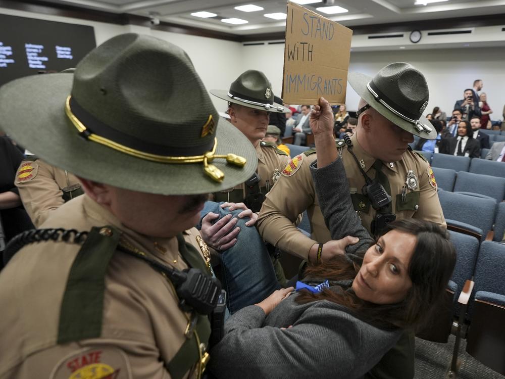 State Troopers remove a protestor during a special session of the Tennessee Legislature last month as it advanced a sweeping immigration bill.