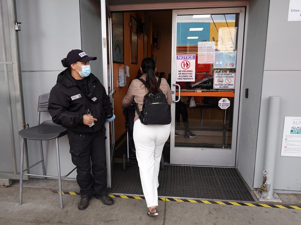 A security guard stands in front of the St. John's Community Health clinic in South Los Angeles.