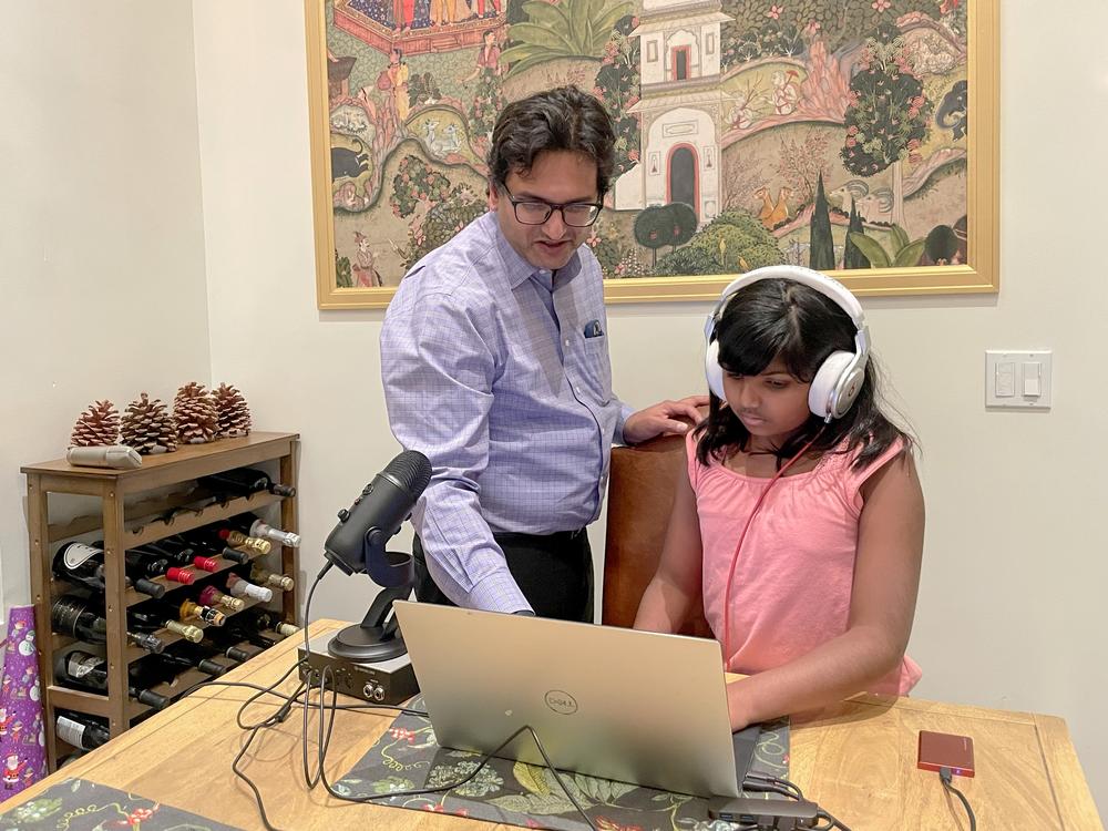 Ameya and her father, Nikhil Desai, re-create their podcast recording set-up at the dining table at their home in San Jose.
