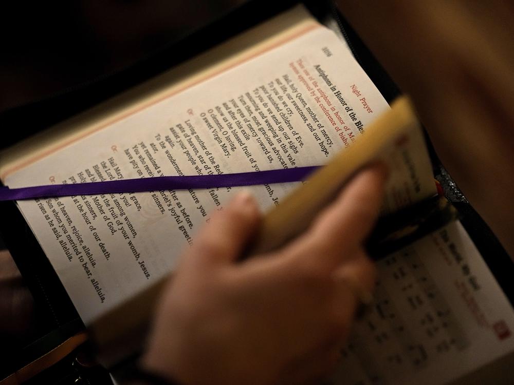 A college student looks through her prayer book. A new study found a decline in Christianity in the U.S.  (AP Photo/Charlie Riedel)