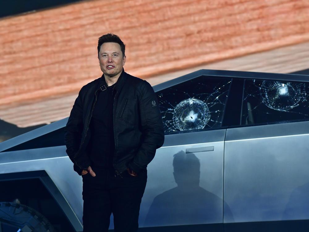 Musk stands in front of the shattered windows of the newly unveiled Tesla Cybertruck on Nov. 21, 2019. Musk has claimed the vehicle is bulletproof, though experts say the 7,000-pound truck would need additional armoring to meet State Department standards.