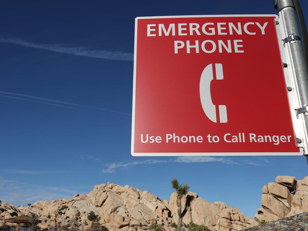 A sign for an emergency phone in California's Joshua Tree National Park. Job cuts are prompting safety concerns, especially given the number of heat-related deaths in national parks in recent summers.