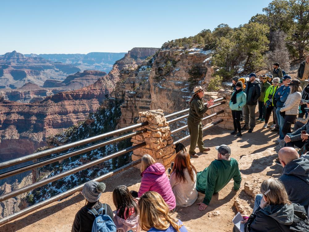 A ranger gives a tour to visitors at Grand Canyon National Park on Saturday. The National Park Service is dealing with the effects of layoffs and the federal hiring freeze.