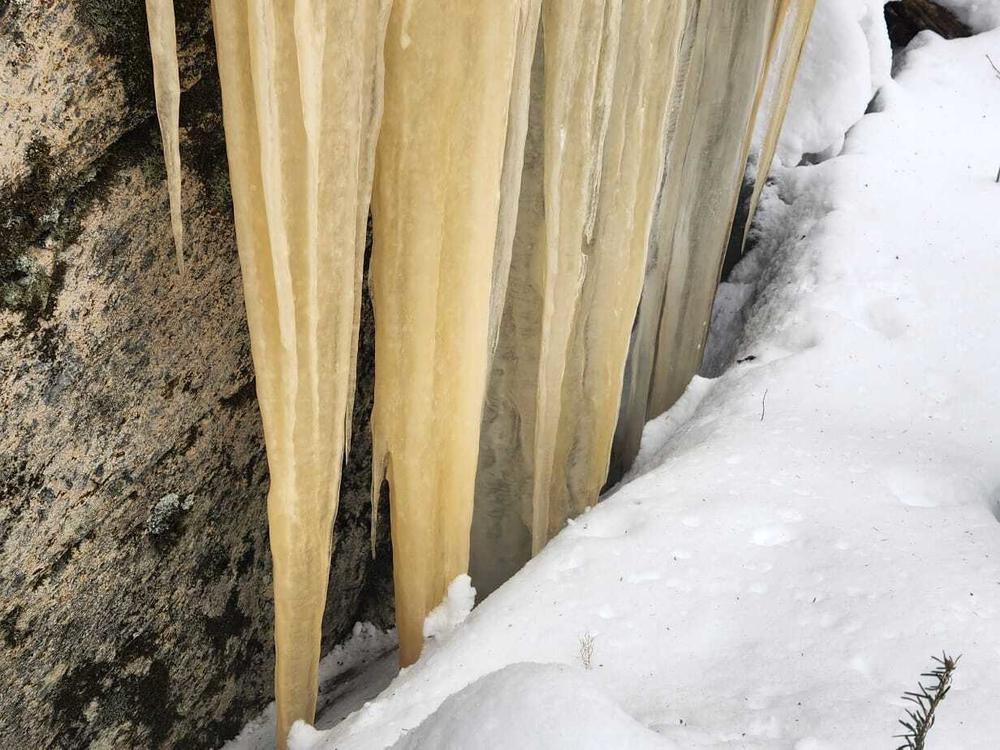 Curtains of ice decorate boulders and cliffs along the trail. It's cold enough to make your breath freeze, but with proper clothing and boots, it feels cozy exploring places like this while warm and comfortable.