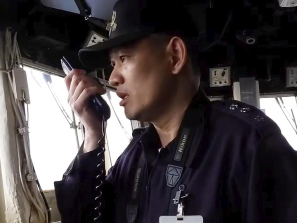 In this image taken off a video released by the Taiwan Ministry of National Defense, a member of Taiwan Navy reacts on the intercom to Chinese war ships conducting drills about 40 nautical miles off the coast of western Taiwan's Kaohsiung and Pingtung cities on Feb. 26, 2025.