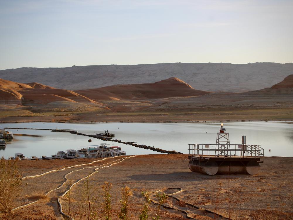 Docks and buoys, once floating atop dozens of feet of water, sit stranded on the shores of Lake Powell on April 9, 2023. President Trump paused funding that was designed to help conserve water and boost the nation's largest reservoirs.