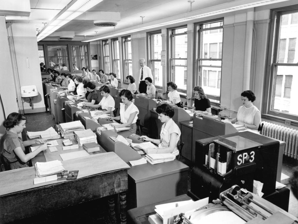 Rows of women office workers entering data using keypads and punch cards at the Erie Railroad offices, Cleveland, Ohio, circa 1960.
