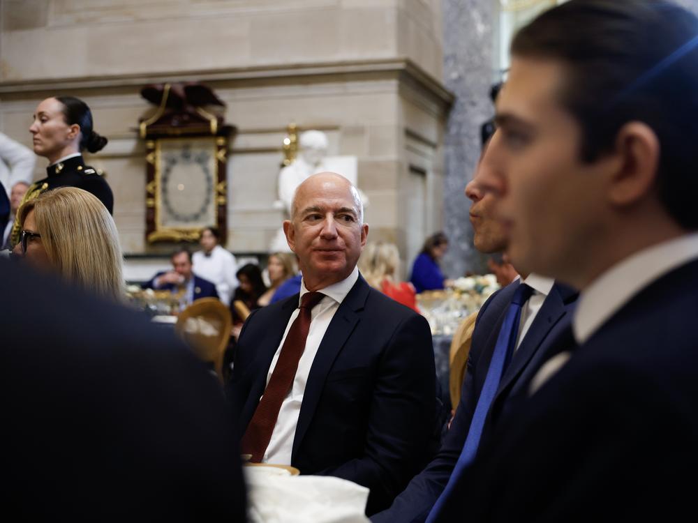 <em>The Washington Post</em> owner Jeff Bezos attends a luncheon following the inauguration of President Trump in January. Bezos says the newspaper's editorial section will publish only 