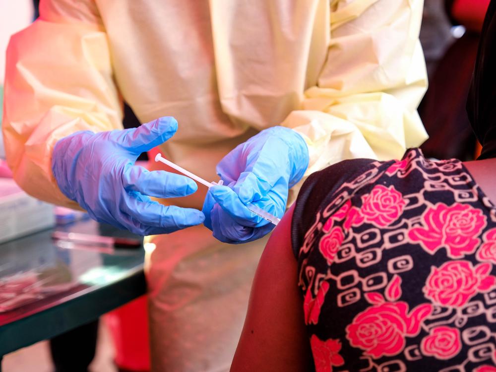A member of a medical team at Mulago Referral Hospital in Kampala, Uganda, administers a dose of a trial Ebola vaccine to a patient on Feb. 3. The country is currently experiencing an Ebola outbreak.