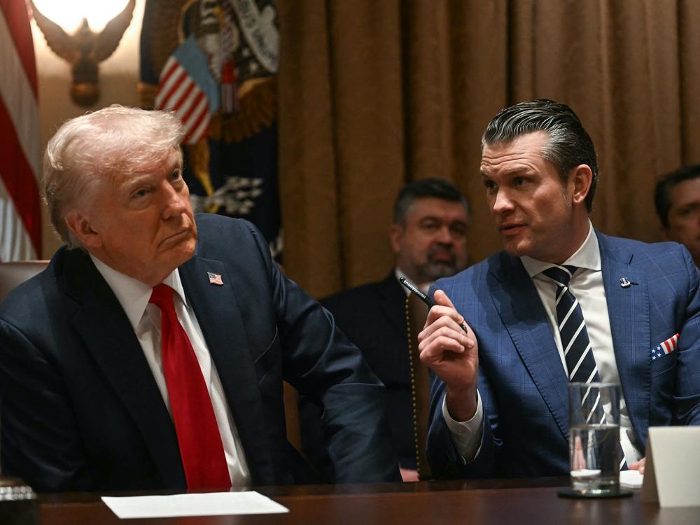 President Trump looks on as Defense Secretary Pete Hegseth speaks during a cabinet meeting at the White House on Wednesday.