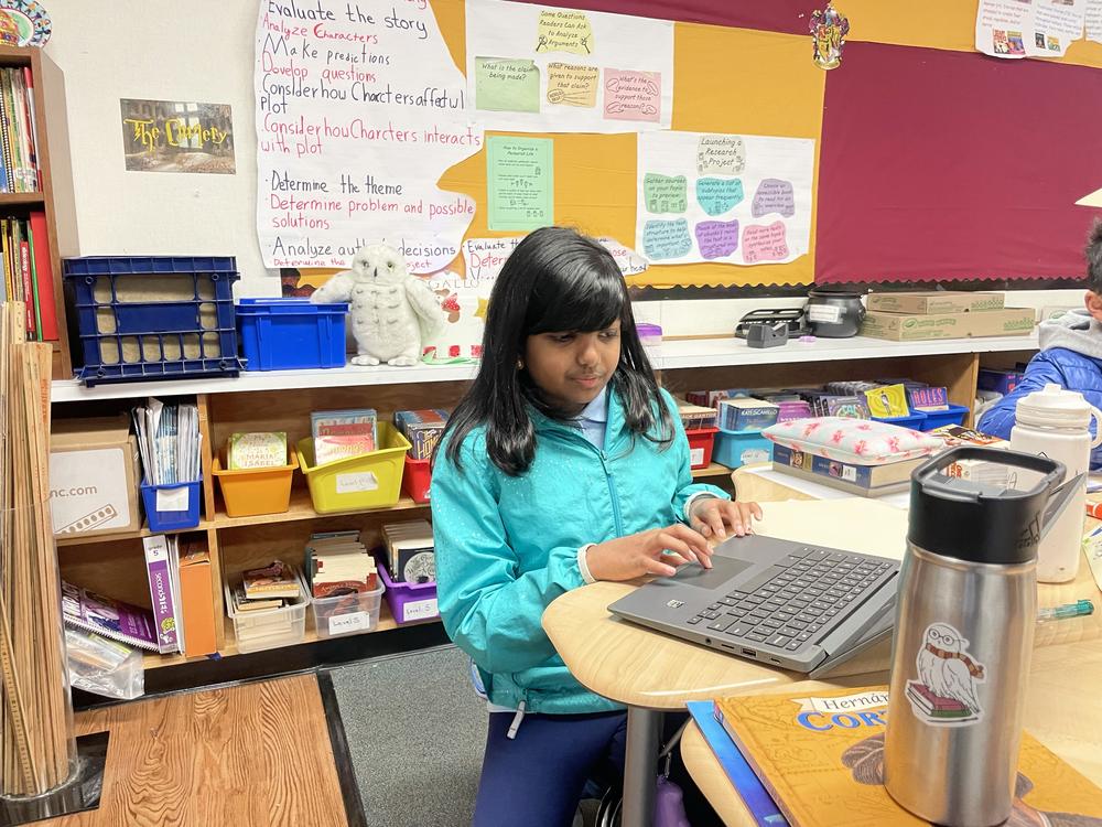 Fifth grader Ameya Desai works at her research project that she's presenting to her class at Williams Elementary School in San Jose, Calif. Her podcast about her grandfather's immigration story was one of the fourth grade winners in the 2024 NPR Student Podcast Challenge.