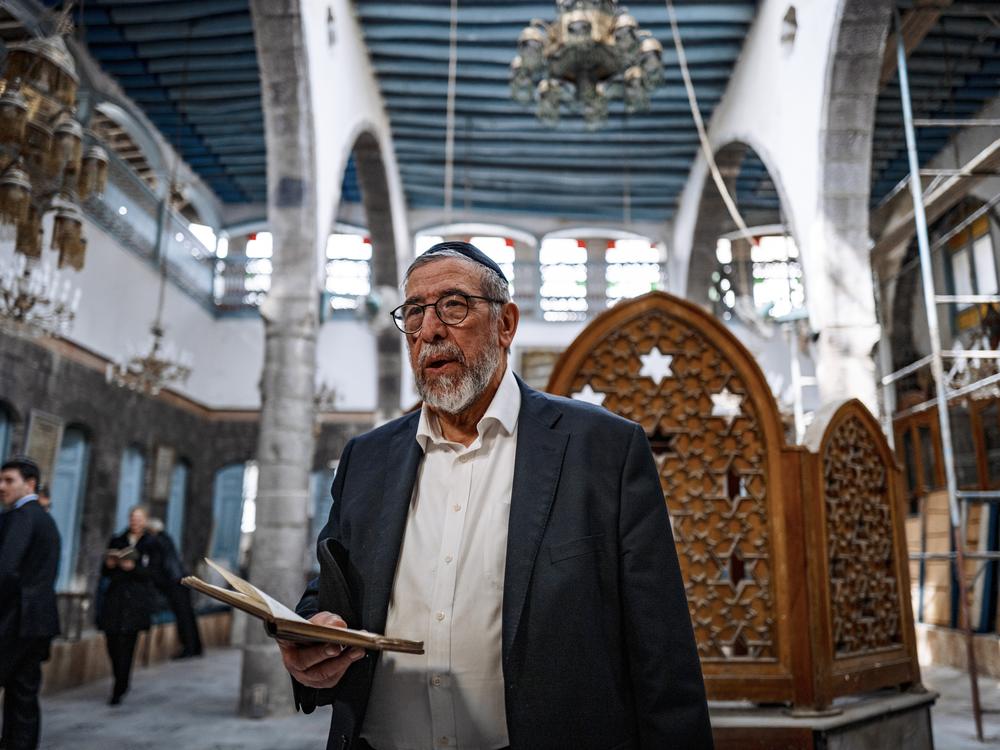 Rabbi Yusuf Hamra says prayers in the Faranj synagogue in Damascus — the first prayers there in more than 30 years.