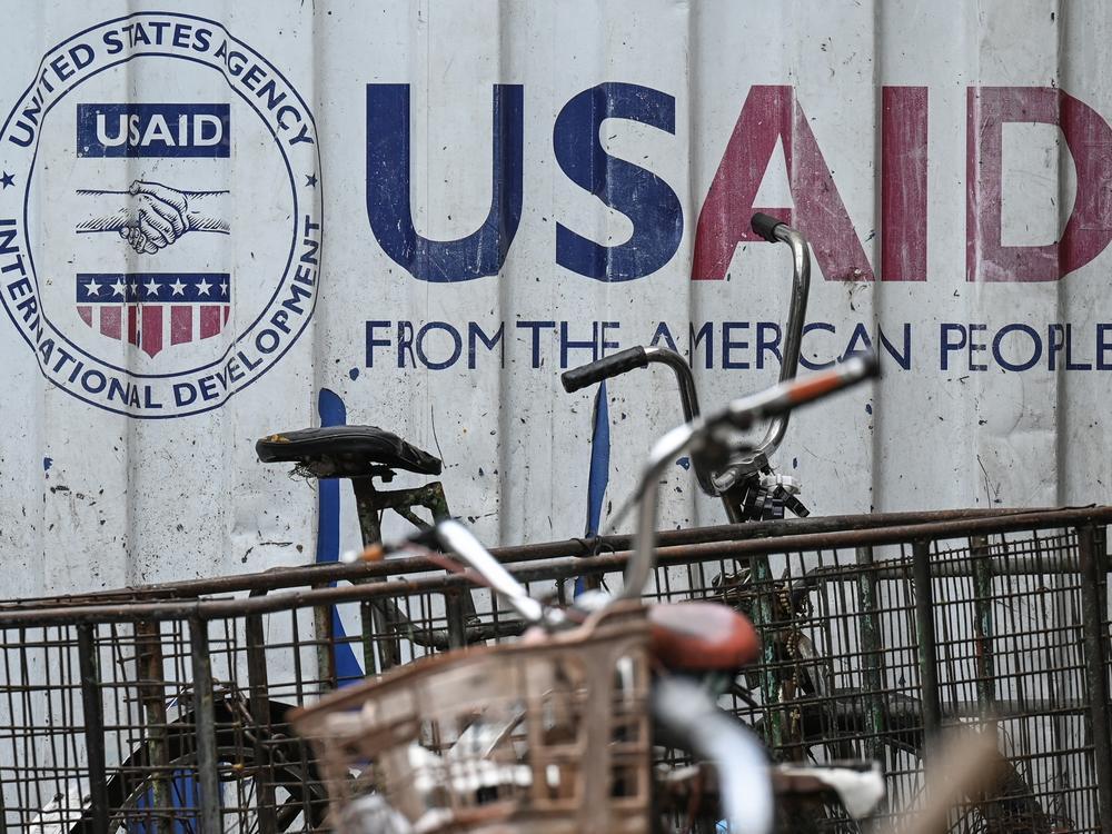 Signage for the US government's humanitarian agency USAID is seen on a cargo container beside a tricycle in Manila on Feb. 4.