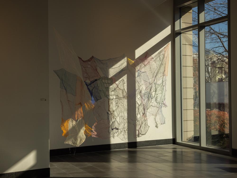 A textile sculpture by Phượng-Duyên Hải Nguyễn is on display.