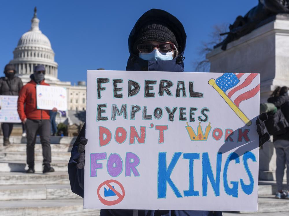 A protester with a sign saying 