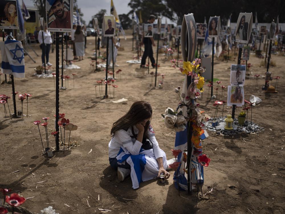 A woman grieves at a memorial for those killed and abducted during the Oct. 7, 2023, cross-border attack by Hamas militants, near the kibbutz Reim, southern Israel on May 13, 2024.