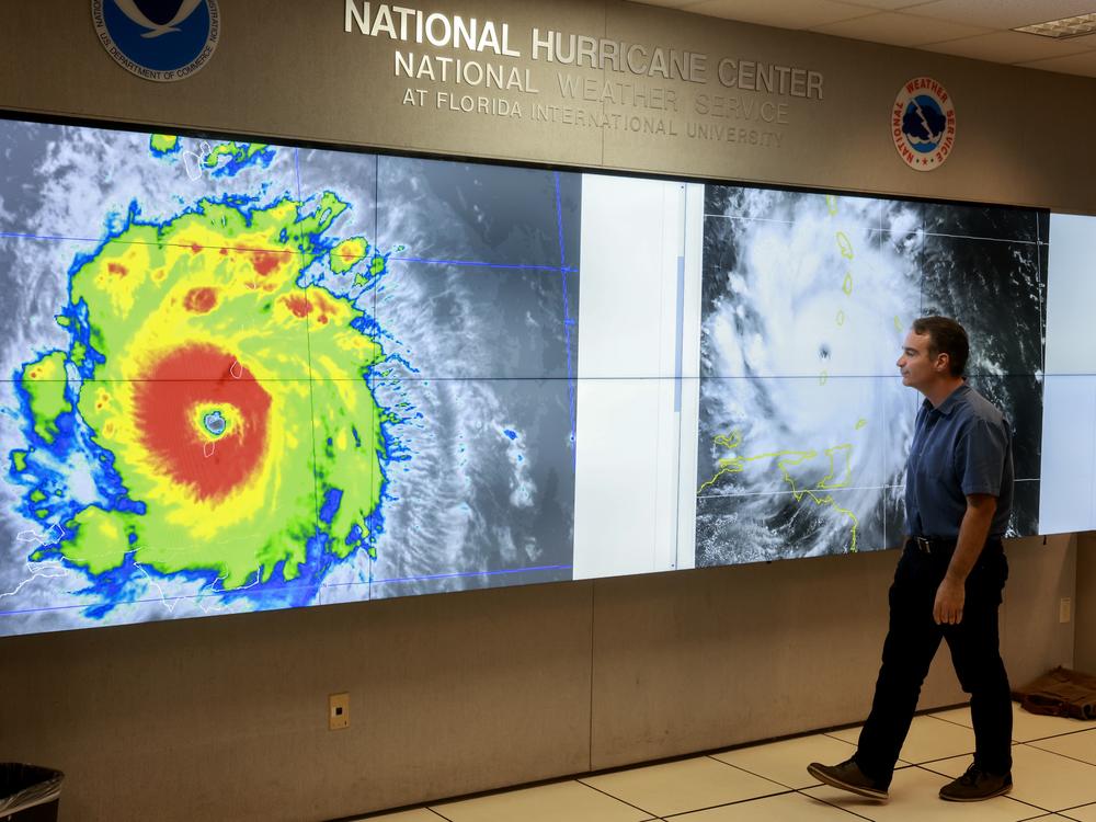 A hurricane specialist looks at a satellite image of Hurricane Beryl, the first hurricane of the 2024 season. The National Hurricane Center provides forecasts of major storms, many of which make landfall in the U.S.. The Center is part of NOAA, the country's oceans- and atmosphere-focused agency. Experts say ongoing staff cuts at the agency could endanger some of its core missions, like forecasting weather.