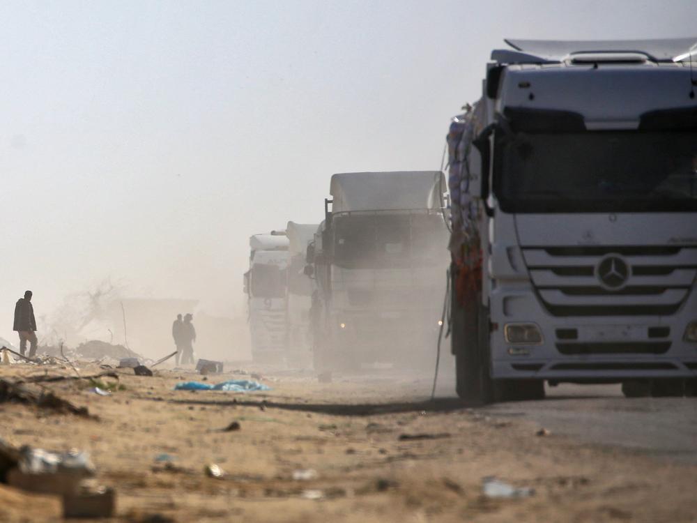 Trucks loaded with humanitarian aid drive through Rafah in the southern Gaza Strip after entering from the Kerem Shalom crossing on February 18, 2025.