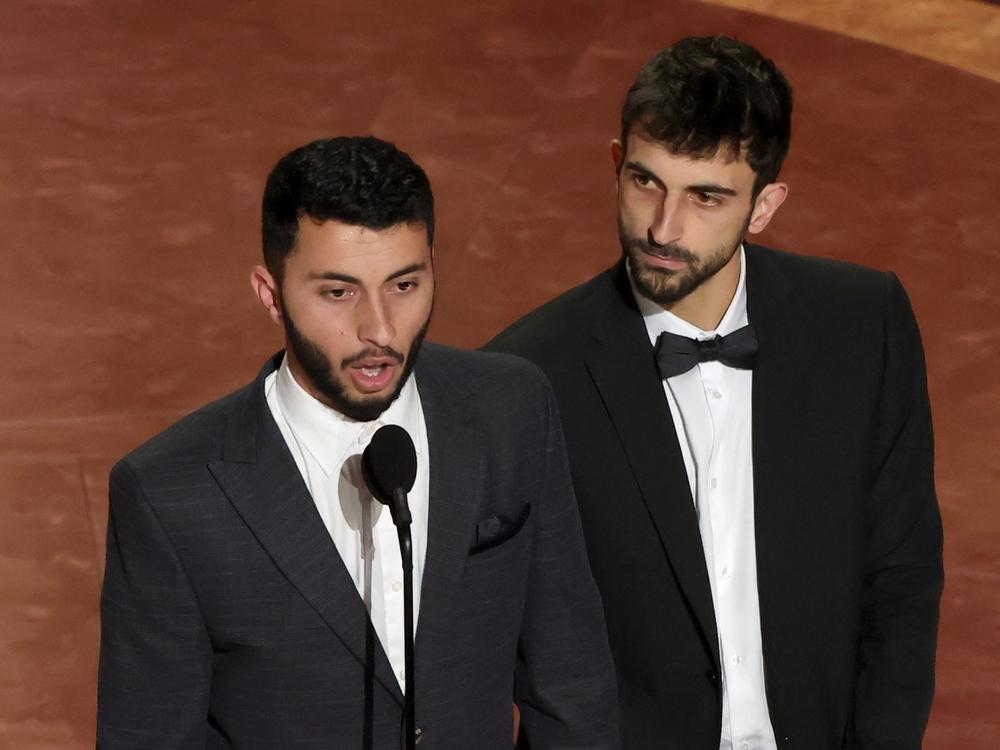 Rachel Szor, left, Hamdan Ballal, Basel Adra and Yuval Abraham accept the Oscar for best documentary feature film for <em>No Other Land.</em>