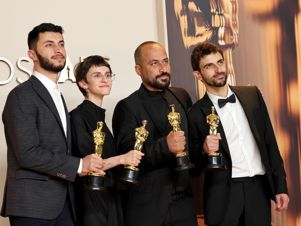 From left: Basel Adra, Rachel Szor, Hamdan Ballal and Yuval Abraham pose with their Oscar awards for best documentary for the film <em>No Other Land</em> in the press room at the 97th Academy Awards in Los Angeles on Sunday.