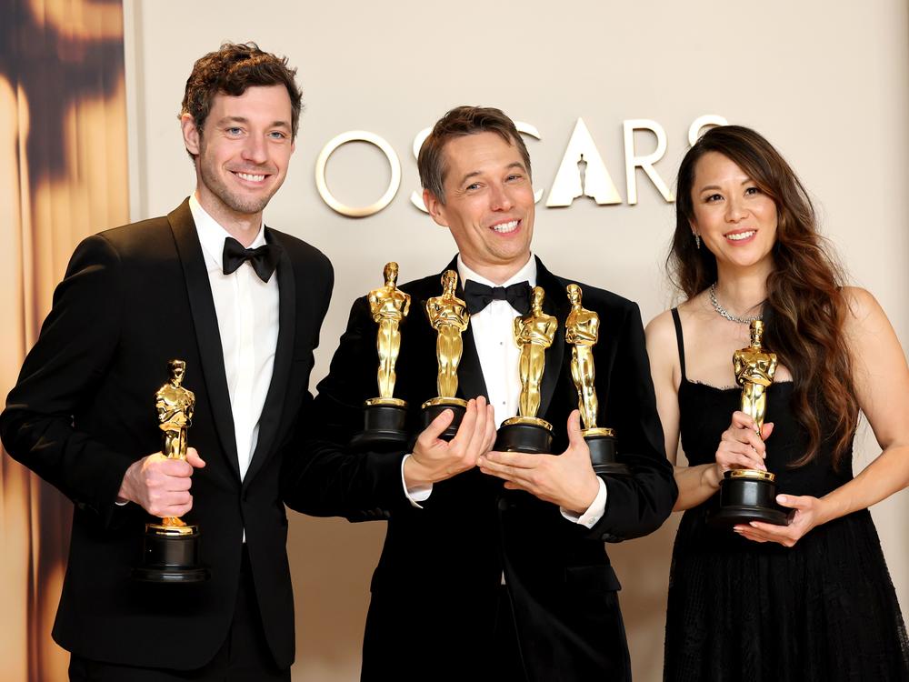 Alex Coco, left, Sean Baker and Samantha Quan pose in the press room with their Oscars for <em>Anora.</em>