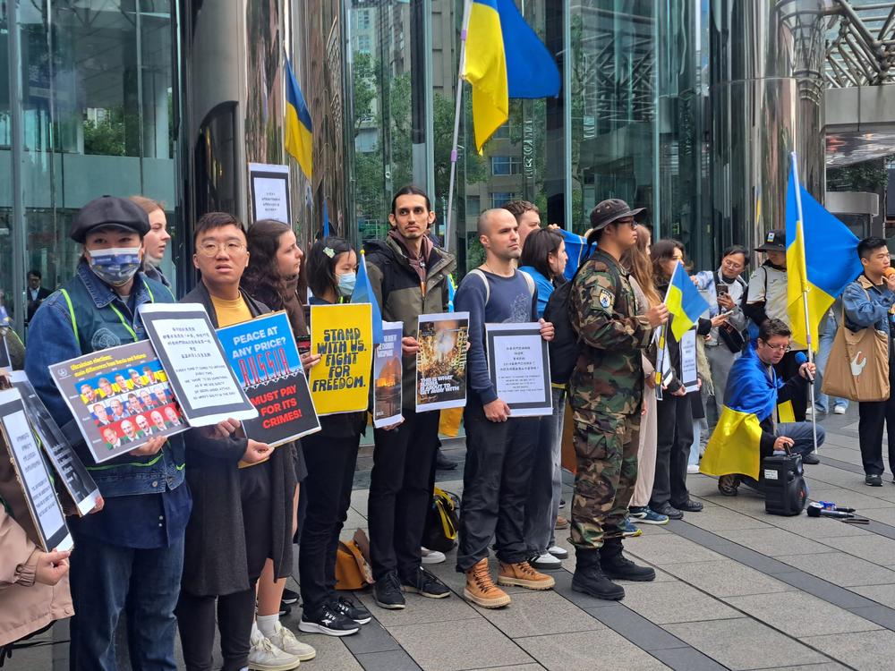 Members of the Ukrainian community in Taiwan, alongside Taiwanese supporters, gather outside Moscow's representative office in Taipei to protest the three-year anniversary of Russia's full-scale invasion of Ukraine