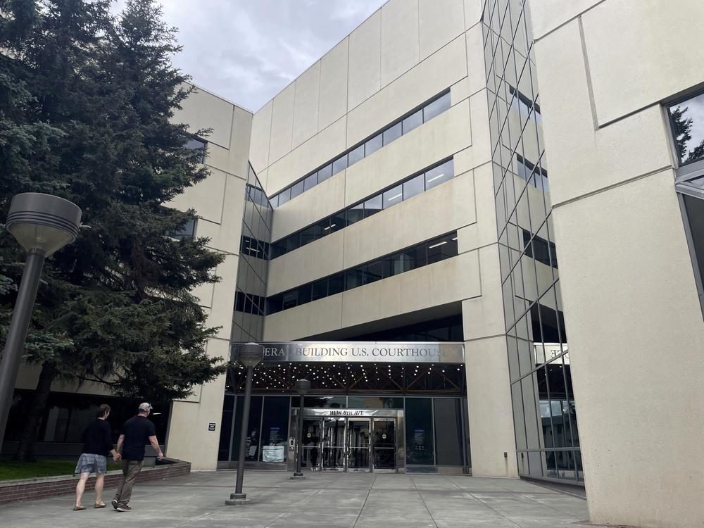 People walk toward the James M. Fitzgerald U.S. Courthouse and Federal Building in downtown Anchorage, Alaska, on July 10, 2024.