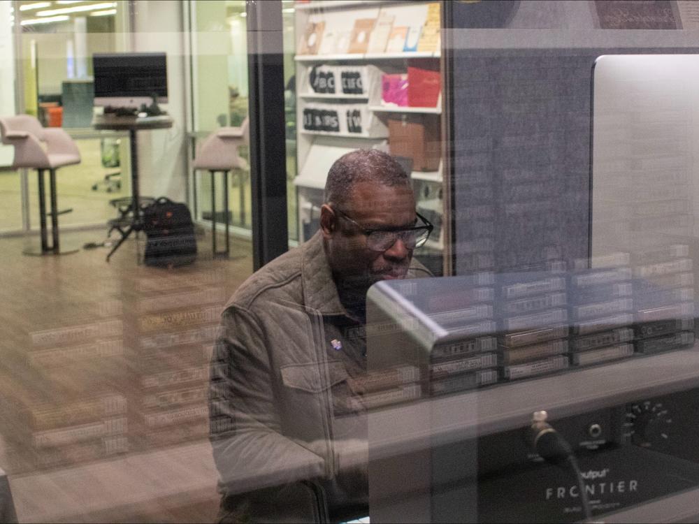 Stephen Newby, research lead for the Black Gospel Archive, sits in the digitization studio housed at the archive. Here, the archive team digitizes and rerecords records that have been donated to the collection.