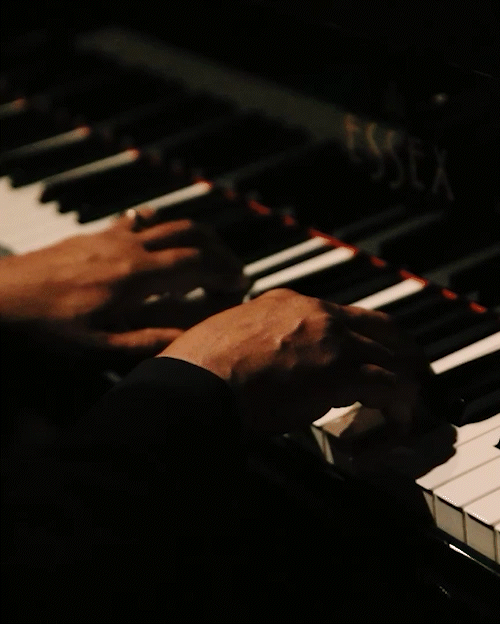 Gerard Gibbs plays the piano during the 