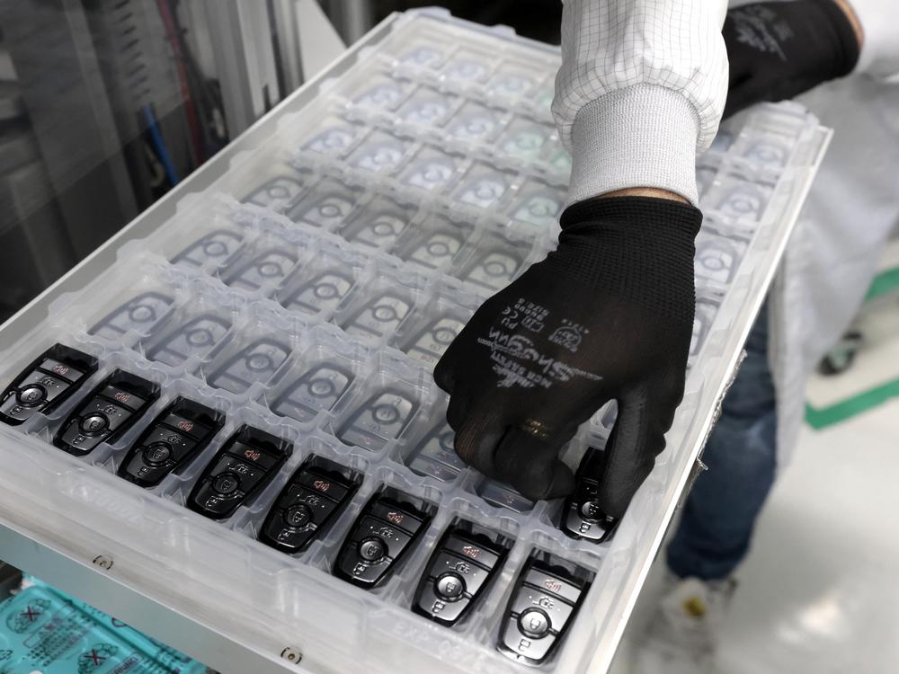 A worker assembles electronic car keys at a manufacturing plant in Tlajomulco de Zuniga, Jalisco State, Mexico, on February 20. The small, handheld remote controls are assembled in Mexico, but they cross borders in North America several times before being finished, like countless other auto parts.