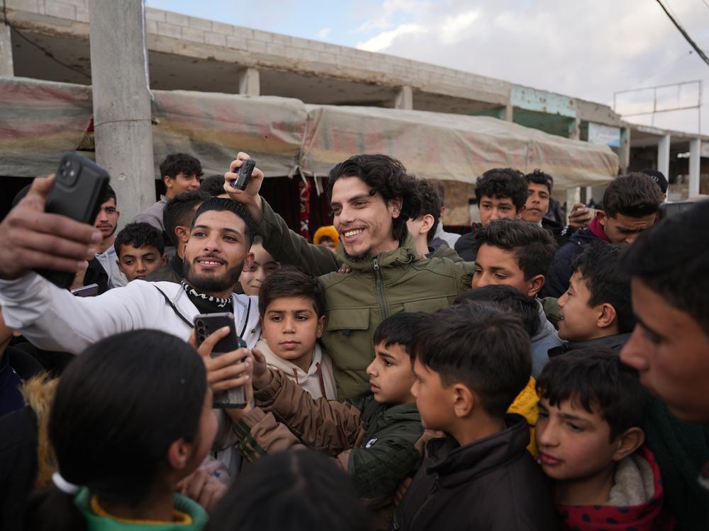 Mohammad al-Sarout, the singer's nephew, took photos with supporters on Jan. 31.