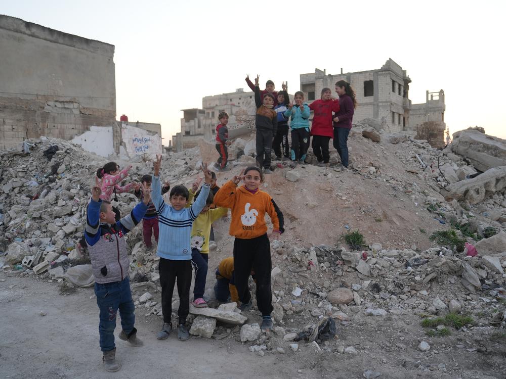 Children gather on the remains of Abdel Basset al-Sarout's former home in Homs, Syria, on Feb. 1.
