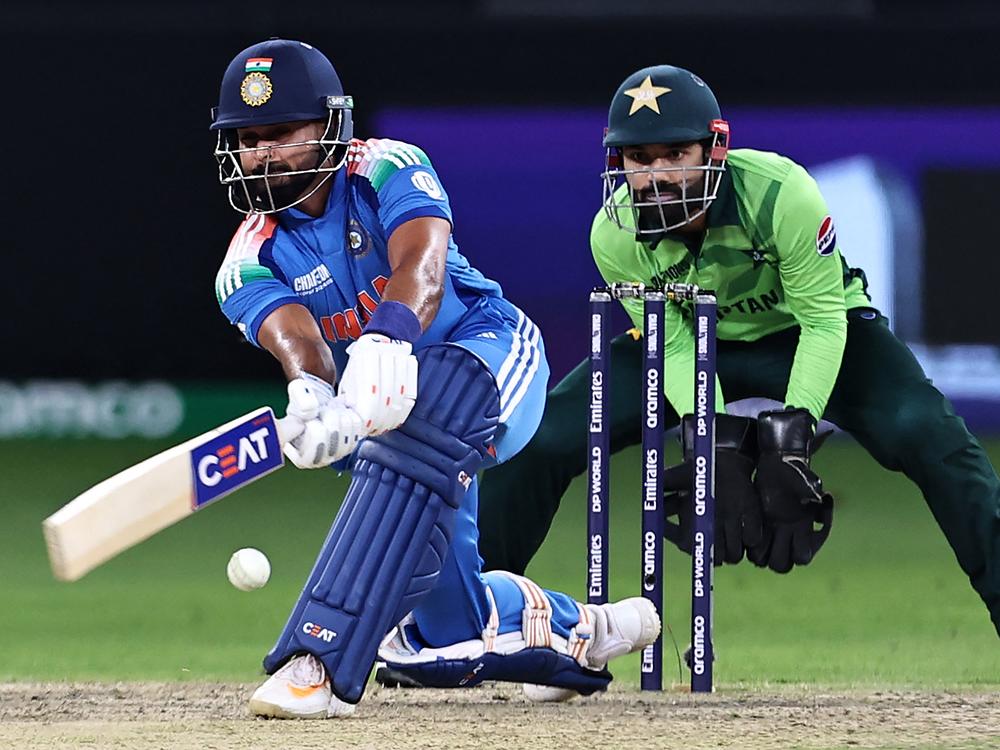 India's Shreyas Iyer (left) plays a shot as Pakistan's wicketkeeper captain Mohammad Rizwan watches during the ICC Champions Trophy one-day international cricket match between Pakistan and India at the Dubai International Stadium on Feb. 23.