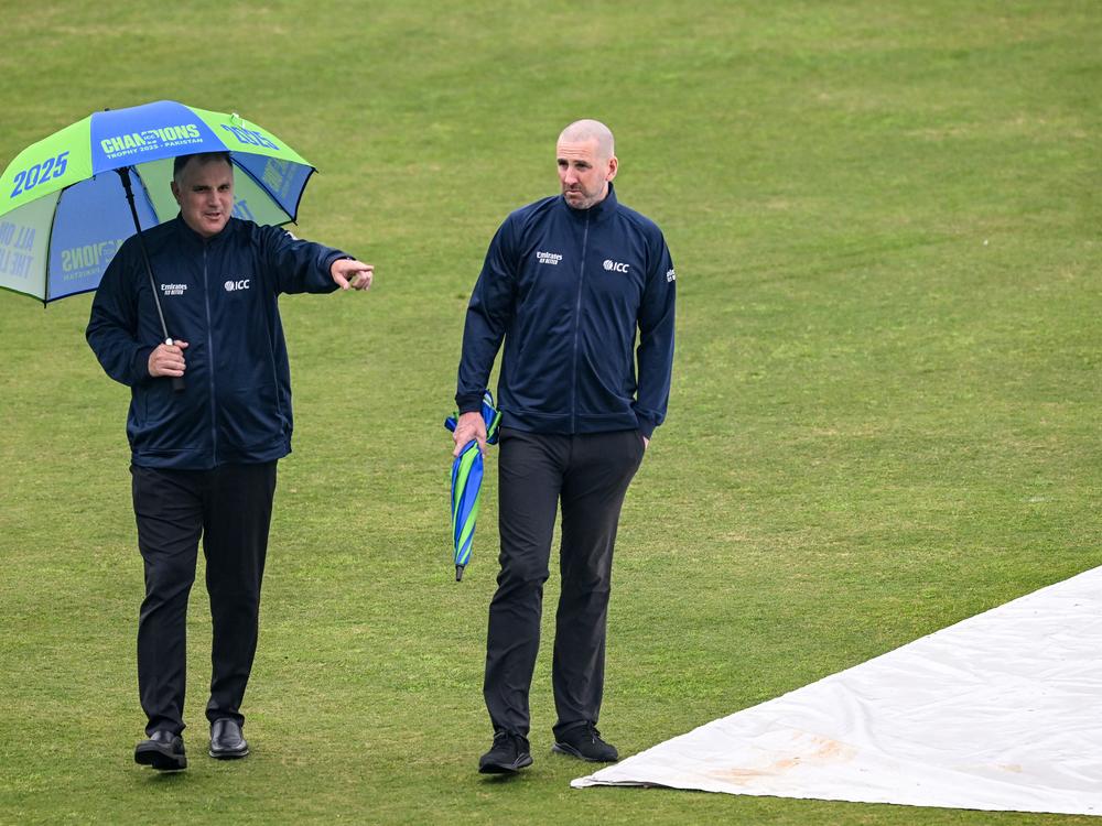 Field umpires Adrian Holdstock (left) and Michael Gough inspect the outfield after rain delayed the start of the ICC Champions Trophy one-day international cricket match between Pakistan and Bangladesh at the Rawalpindi Cricket Stadium on Feb. 27.