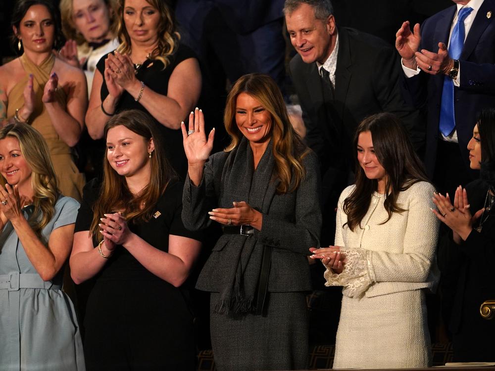First Lady Melania Trump (center) waves as she attends US President Donald Trump's address to a joint session of Congress in the House Chamber of the Capitol.