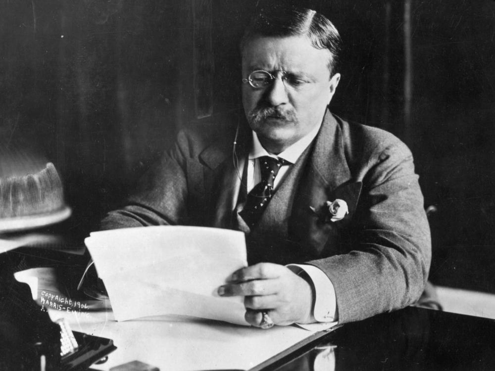 President Theodore Roosevelt works at his desk circa 1905.