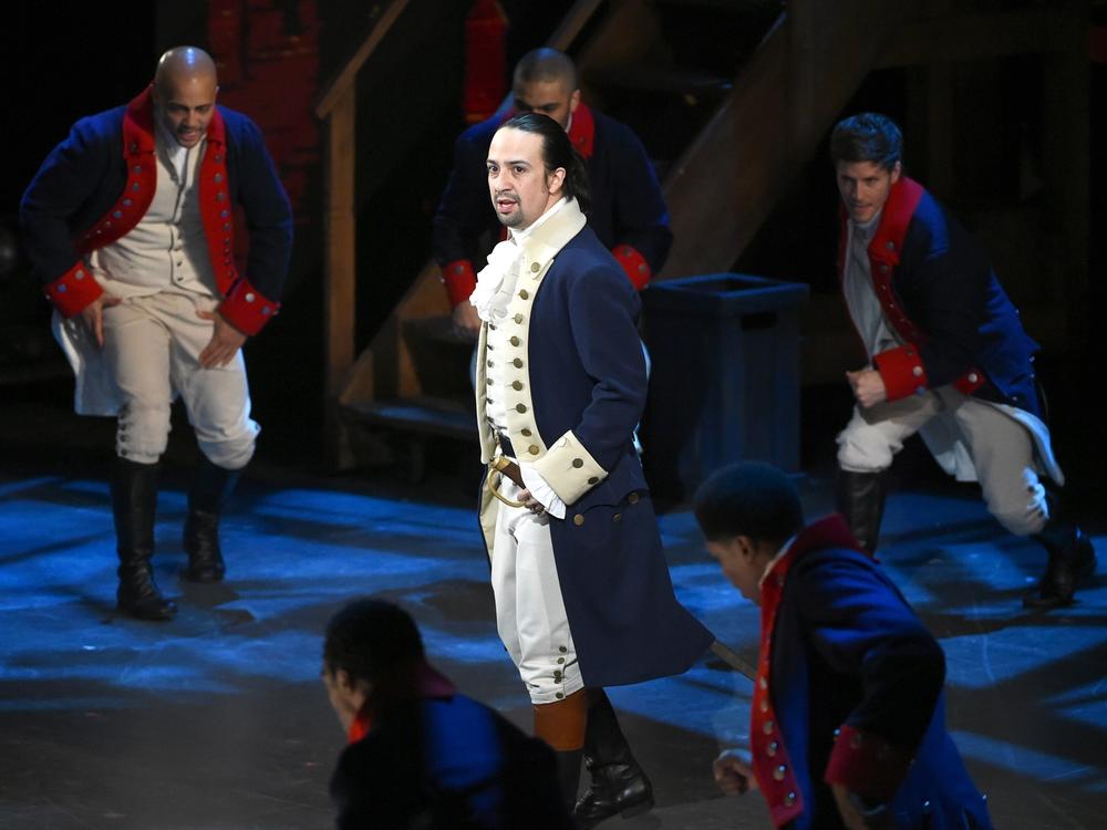Lin-Manuel Miranda and the cast of <em>Hamilton</em> perform at the Tony Awards in 2016. The show has garnered near-universal acclaim since its 2015 opening.