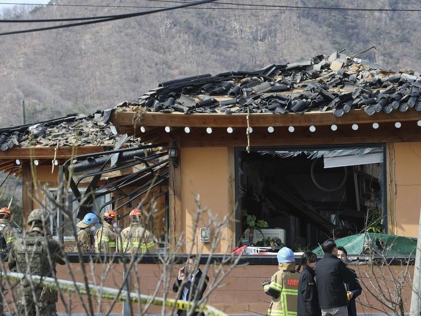 Rescue members work at a bomb accident site where a South Korean fighter jet accidentally dropped bombs on a civilian area during training, in Pocheon, South Korea, Thursday, March 6, 2025. (Yonhap via AP)