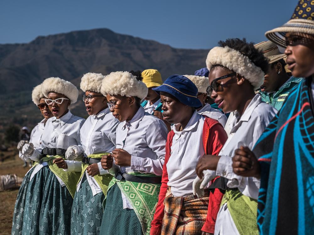Community members perform a dance and song in the village in Leribe, Lesotho, Oct. 2, 2024.