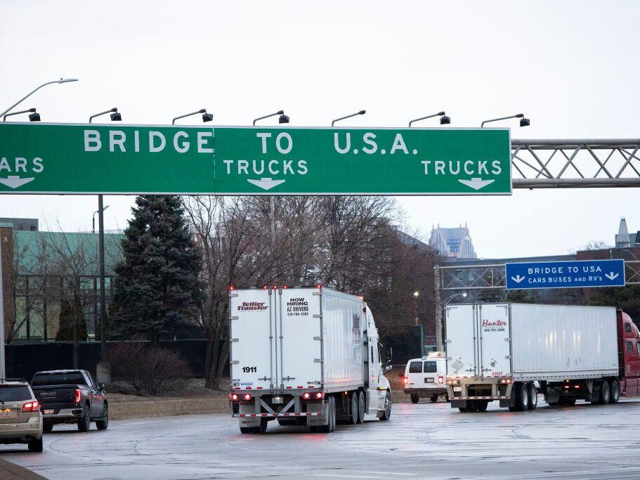 Trucks head to the Ambassador Bridge between Windsor, Canada and Detroit, Michigan on the first day of President Donald Trump's new tariffs on Canada, Mexico and China.