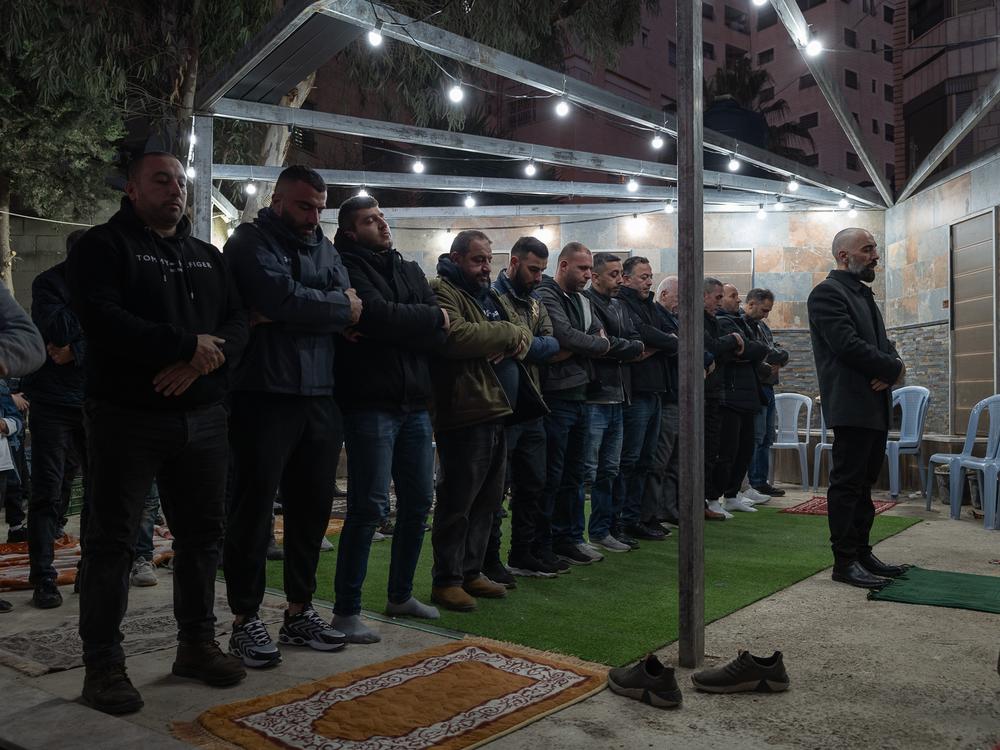 Ashraf Zughayer leads a prayer at the family celebration.