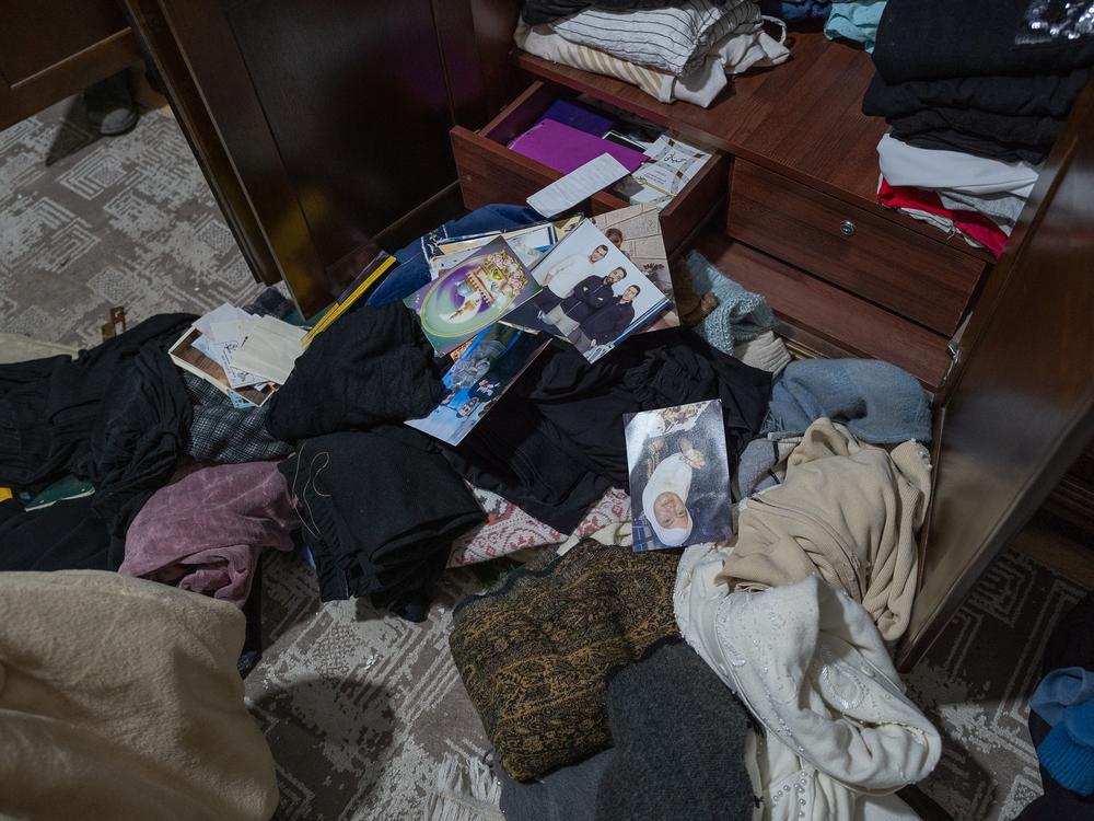 Clothing, photographs and other household items are scattered on the floor after Israeli authorities raid the East Jerusalem home of Ashraf Zughayer following his release from prison.
