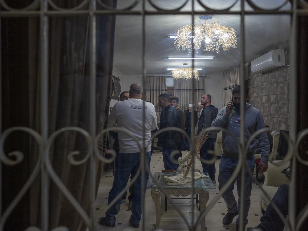 Zughayer family members are gathered in their home after Israeli forces arrested their relatives, on Jan. 25. Neighbors are on edge that they could also be raided if they celebrate the return of their loved ones from prison.