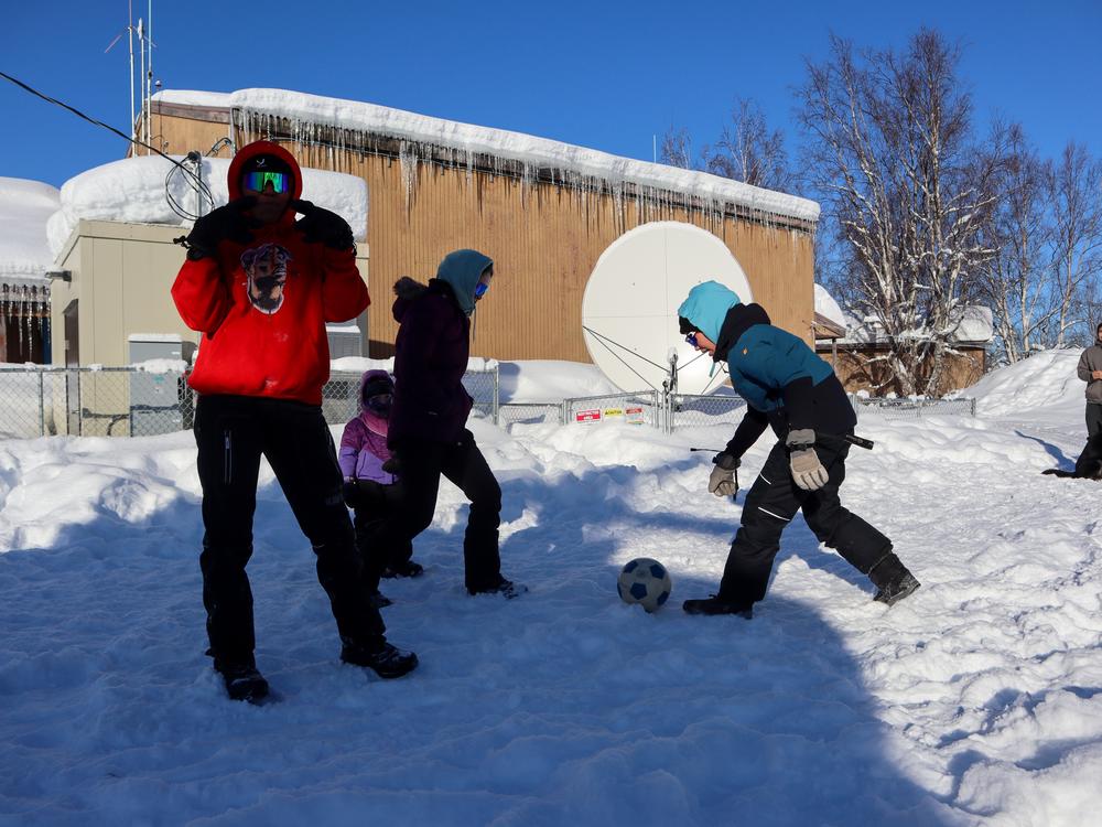 Sleetmute students play soccer during recess last spring. In the coldest months, when temperatures fall well below zero, the kids can't have recess because the gym is closed.