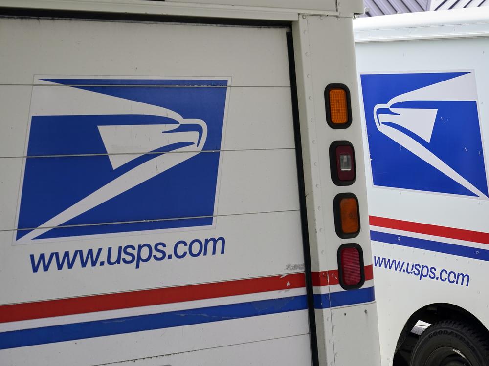 U.S. Postal Service delivery vehicles are parked outside a post office in Boys Town, Neb., on Aug. 18, 2020.