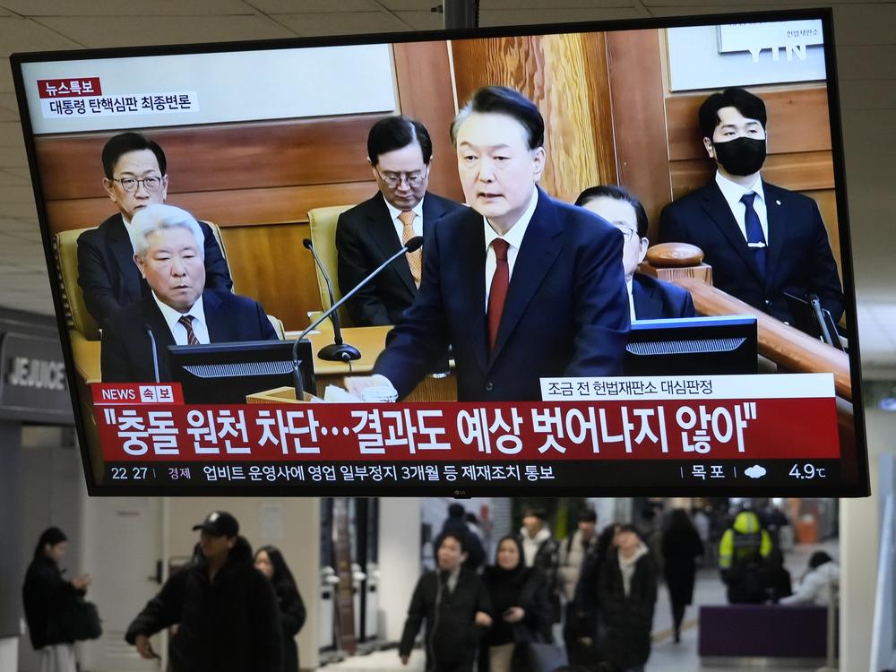 A TV screen shows footage of impeached South Korean President Yoon Suk Yeol's address at the final hearing of his trial during a news program at a bus terminal in Seoul, South Korea on Tuesday, Feb. 25, 2025.