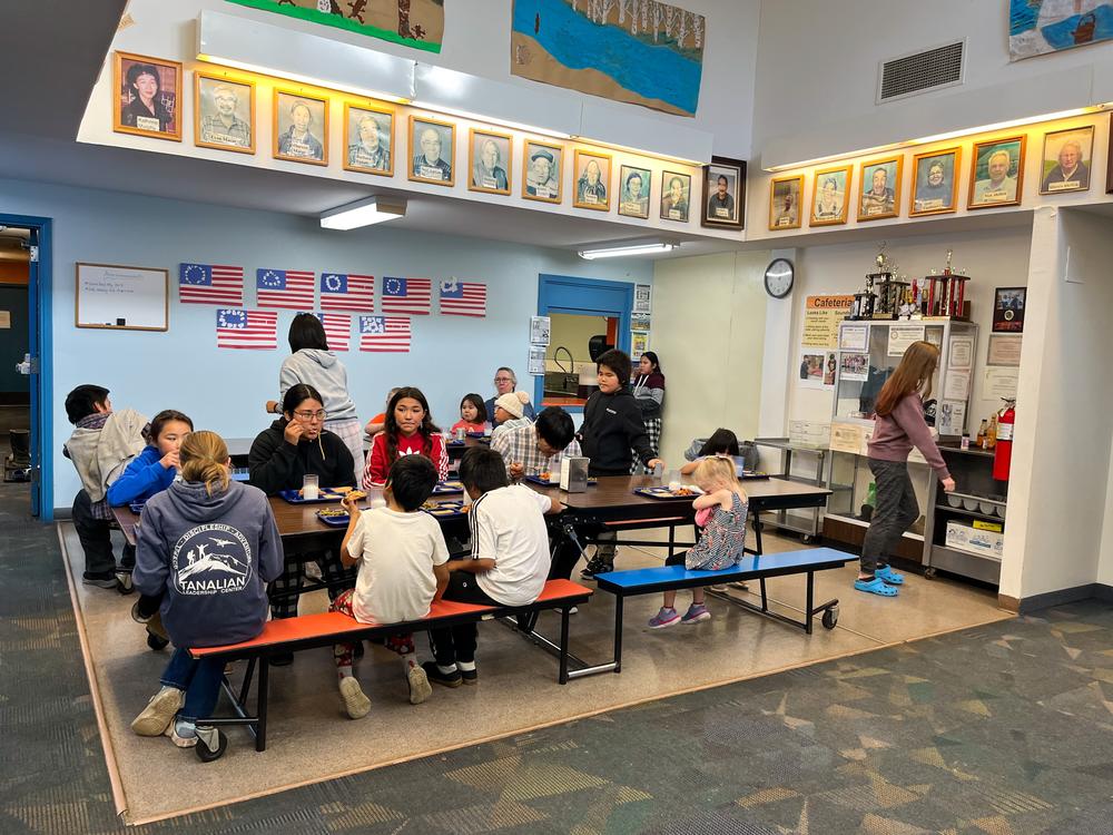 A small atrium is one of the few spaces Sleetmute students can use. They eat breakfast and lunch here, surrounded by portraits of the village's Yup'ik and Athabascan elders.