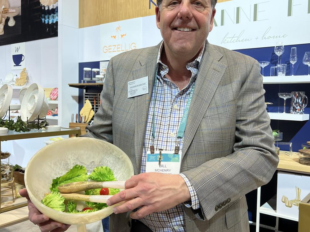 Bill McHenry, president and CEO of the Chicago-based company Widgeteer, holds one of his company's resin salad bowls on the floor of the Inspired Home Show.