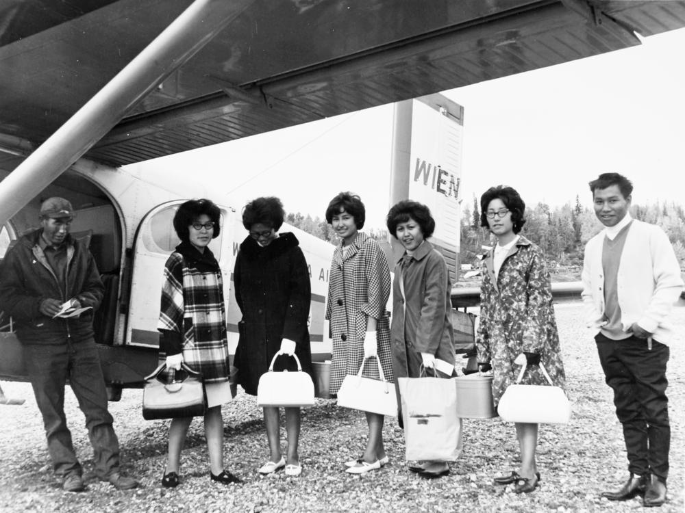 Teenagers board a plane in Shungnak, Alaska, on their way to Oregon to attend boarding school. The people were identified as, from left, George Cleveland Sr., Lena Commack Coffee, Angeline Douglas, Genevieve Douglas Norris, Wynita Woods Lee, Virginia Douglas Commack and Harold Barry.